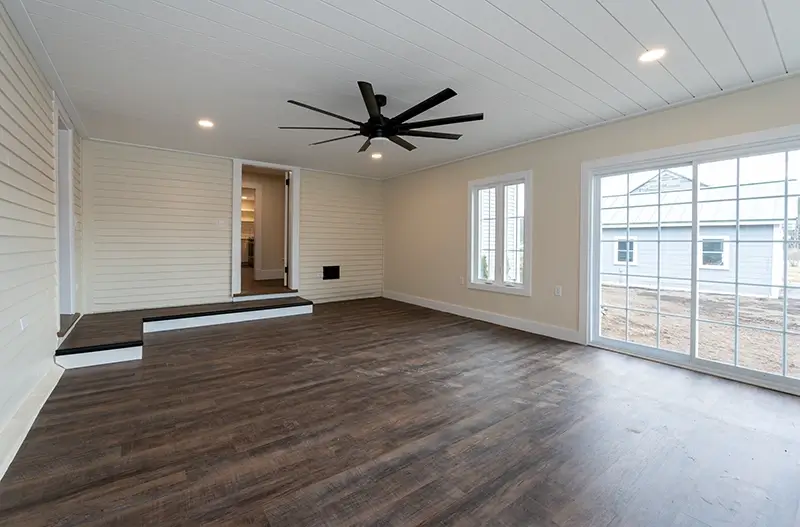New addition room with hardwood floors and ceiling fan