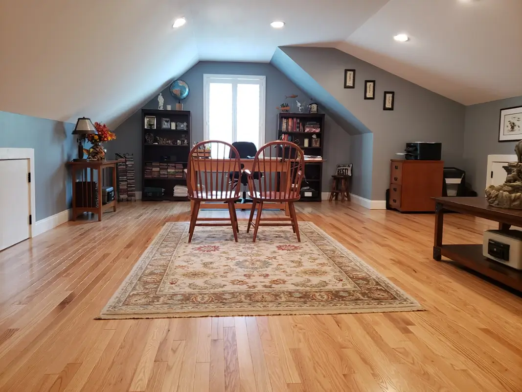 Newly remodeled attic, space with hardwood floors, fresh paint, and recessed lighting