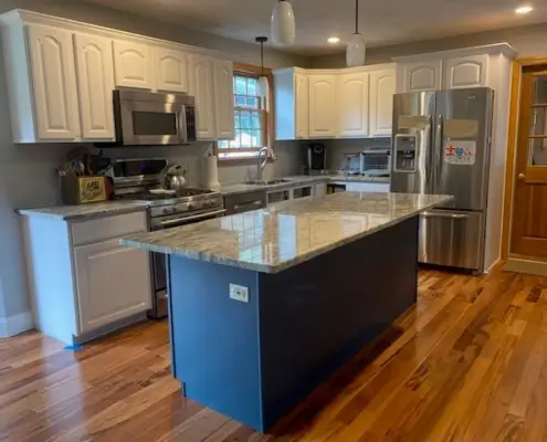 Newly remodeled kitchen, with new white cabinets, granite countertops, stainless steel, new appliances, and hardwood floors