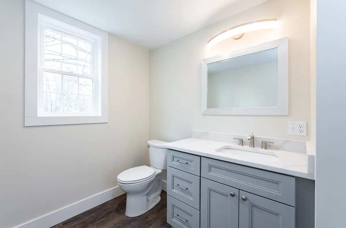Beautifully remodeled bathroom with new sink vanity, toilet, and fresh paint