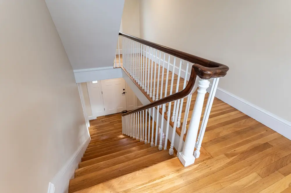Refinished hardwood floors in hallway and on staircase