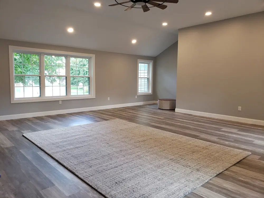 New home addition bonus room with hardwood floors, freshly painted walls, recessed, lighting, and ceiling fan