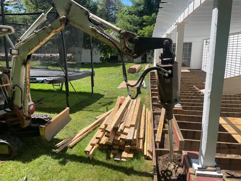 New porch installation drill working on construction site