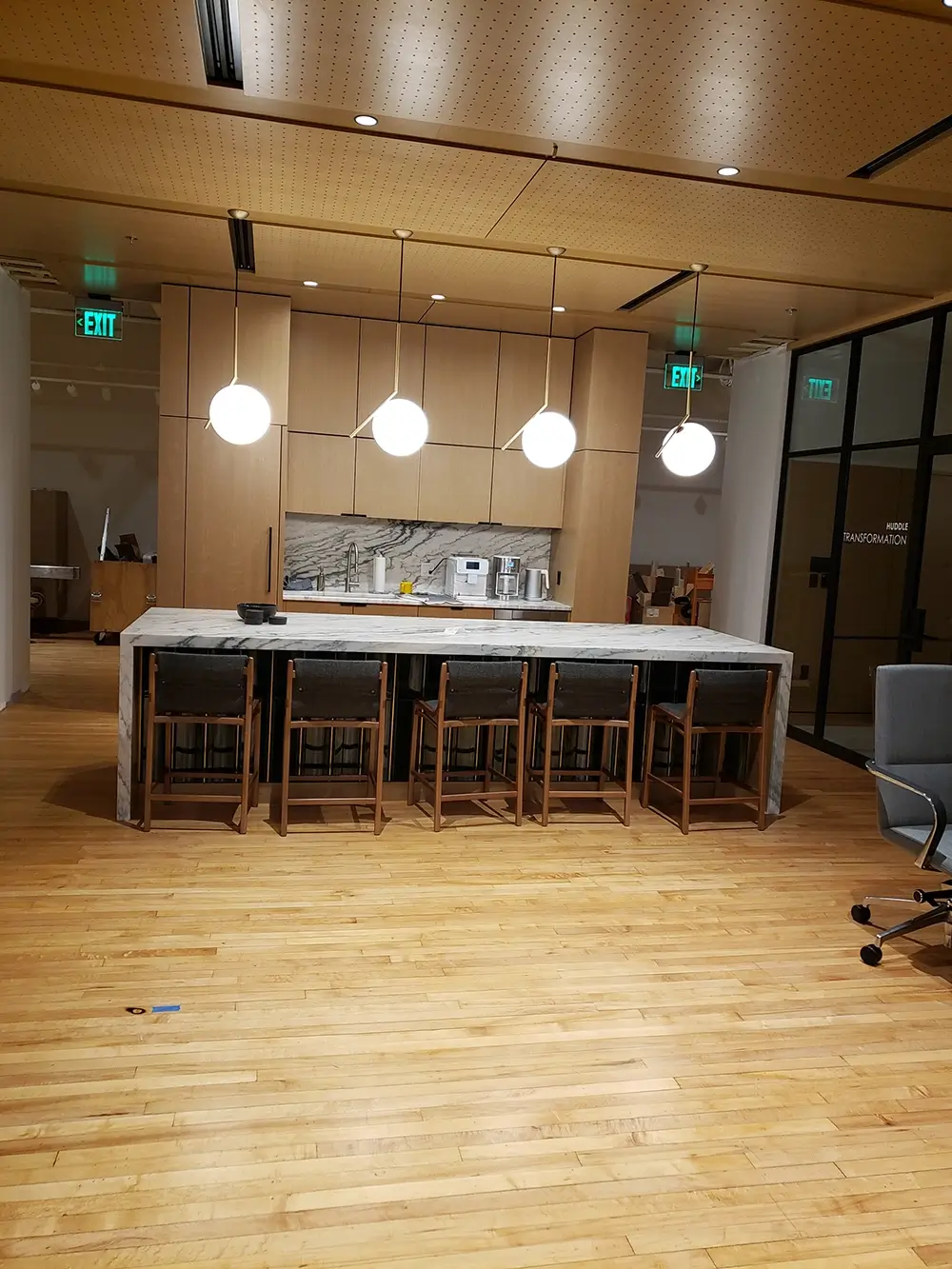 Newly remodeled commercial office, kitchen space with pendant lights and dining table