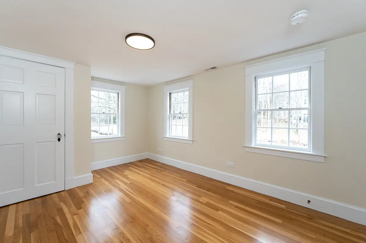 Newly renovated bedroom with new hardwood floors and windows