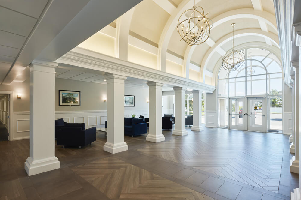 Beautifully remodeled commercial entry hall with soaring arched ceilings, and two chandeliers