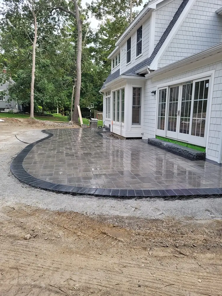 Hardscapes new stone patio behind home