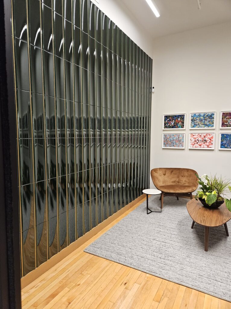 Wait Room at Wagner Foundation with decorative glass wall, paintings and plants, Cambridge MA