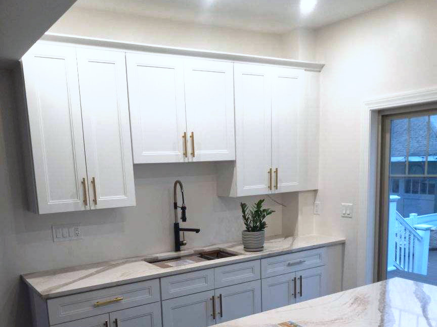 Kitchen Remodeling with beautiful granite countertops, white cabinets and navy blue island cabinet